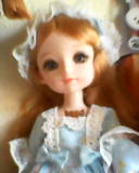 a bust shot of a pale blonde doll