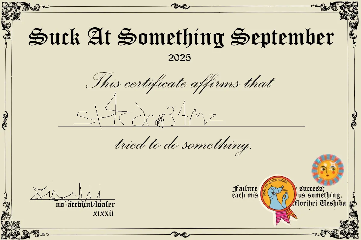 a certificate with the website's name crudely drawn on it, as well as a fancy looking title that says Suck at Something September. There are 2 cute round stickers in the bottom right corner